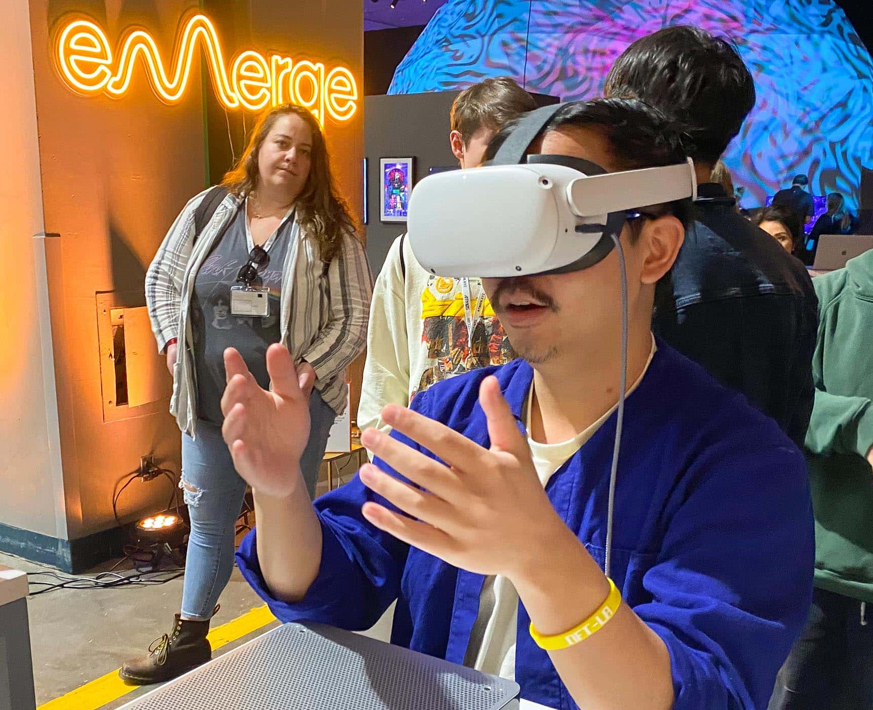 An attendee tries out the haptic-enabled eMerge VR glasses at NFT LA.