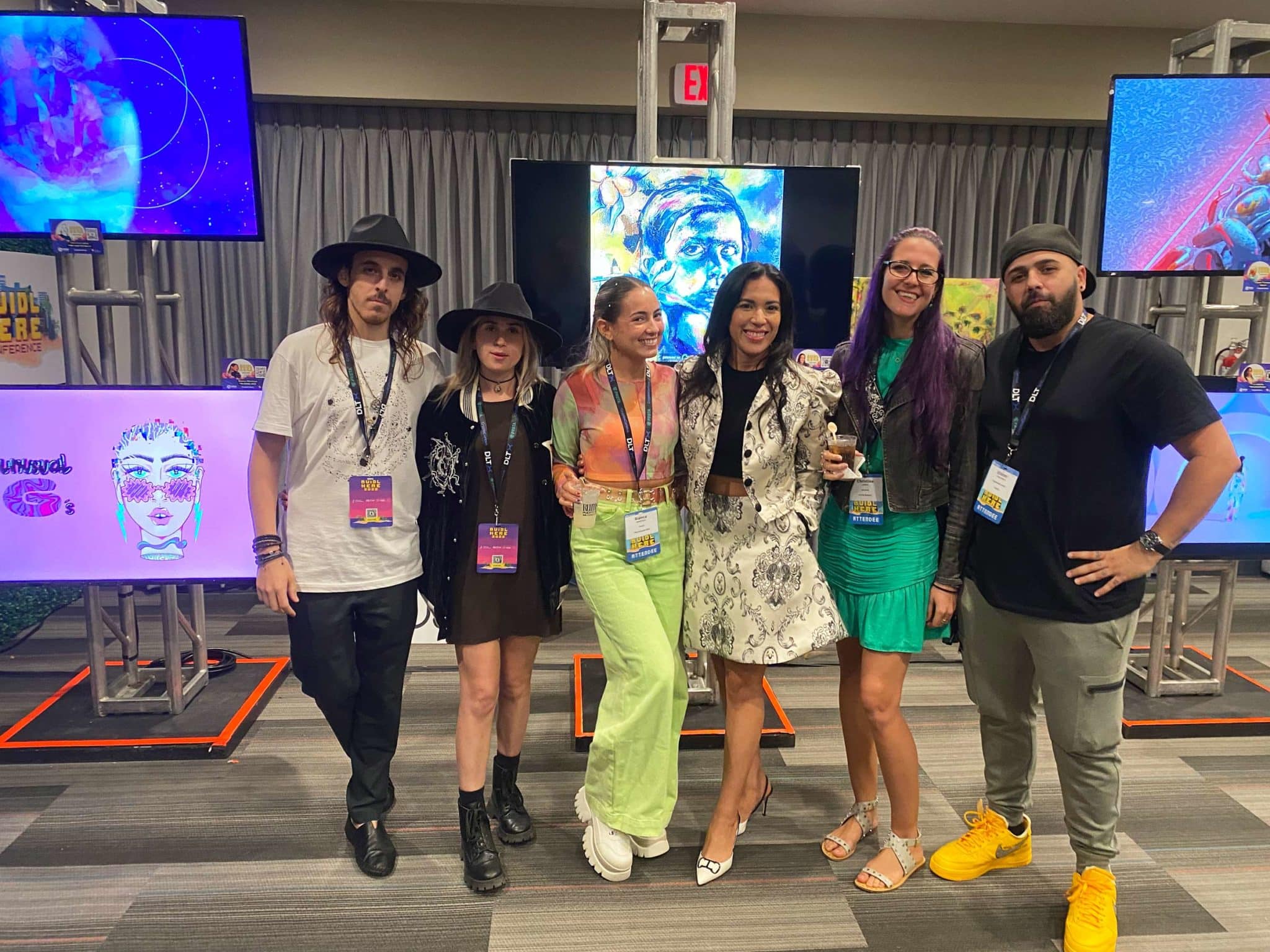 Local NFT artists in front of some of their works at BUIDL HERE during Puerto Rico Blockchain Week.